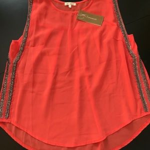 Francesca’s orange tank top blouse.